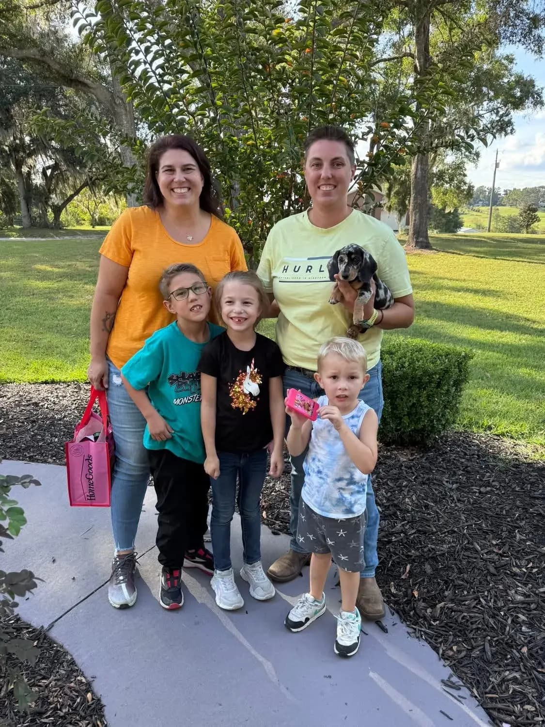 A family picking up their Miniature Dachshund puppy at Irish Rose Acres